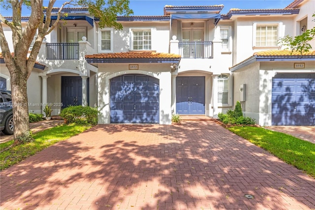 8122 SW 119th Ct Unit 8122, Miami, FL 33183 - view of front of property with a balcony, stucco siding, a tiled roof, and an attached garage