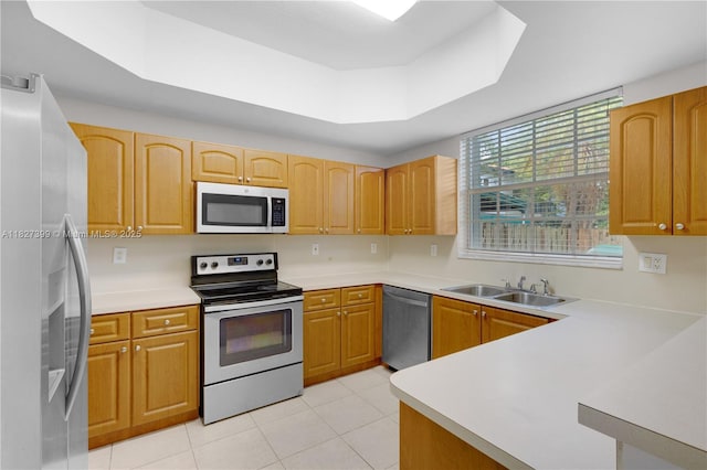 8122 SW 119th Ct Unit 8122, Miami, FL 33183 - kitchen with stainless steel appliances, light tile patterned floors, a tray ceiling, and light countertops