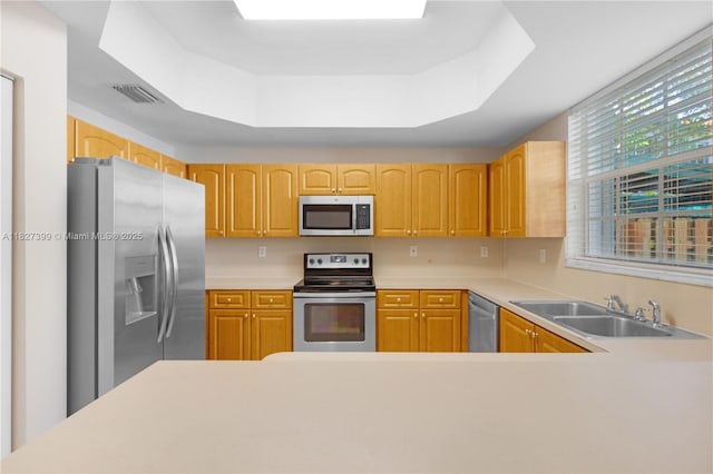 8122 SW 119th Ct Unit 8122, Miami, FL 33183 - kitchen featuring stainless steel appliances, a raised ceiling, light countertops, and light brown cabinets