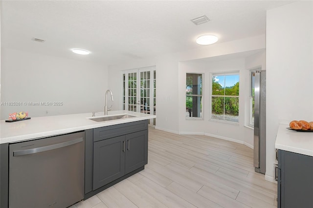 315 W Cypress Cove Cir, Davie, FL 33325 - kitchen with appliances with stainless steel finishes, light countertops, plenty of natural light, and light wood-style flooring