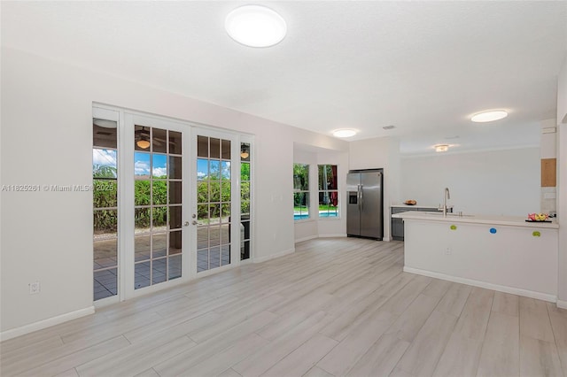315 W Cypress Cove Cir, Davie, FL 33325 - kitchen with stainless steel refrigerator with ice dispenser, a peninsula, light countertops, and light wood-style flooring