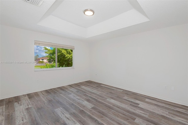 315 W Cypress Cove Cir, Davie, FL 33325 - unfurnished room featuring a tray ceiling and wood finished floors