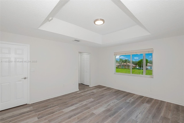 315 W Cypress Cove Cir, Davie, FL 33325 - unfurnished bedroom featuring a tray ceiling, wood finished floors, a textured ceiling, and a closet