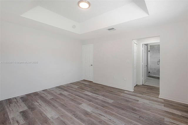 315 W Cypress Cove Cir, Davie, FL 33325 - spare room featuring a raised ceiling and wood finished floors