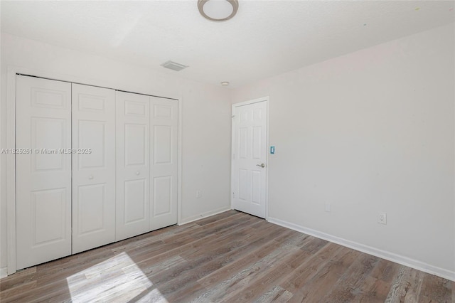315 W Cypress Cove Cir, Davie, FL 33325 - unfurnished bedroom with wood finished floors and a closet