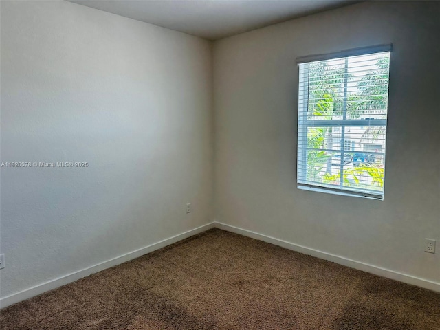 1672 SE 8th Ave, Homestead, FL 33034 - unfurnished room featuring dark carpet and baseboards