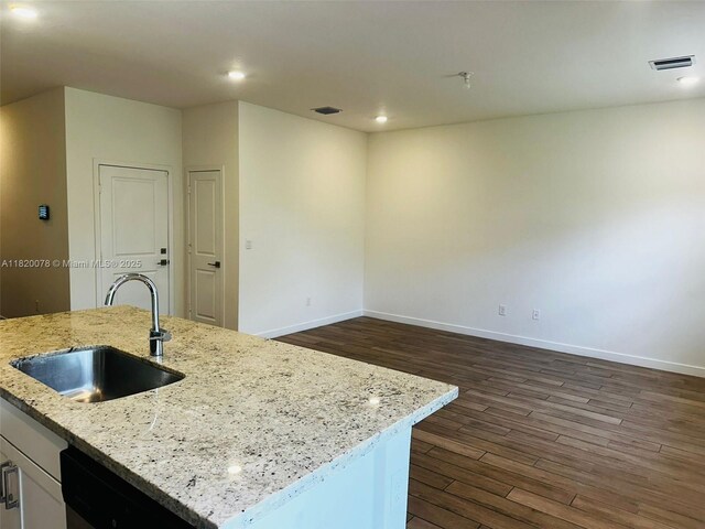 1672 SE 8th Ave, Homestead, FL 33034 - kitchen with dark wood-style floors, dishwashing machine, recessed lighting, light stone countertops, and white cabinets