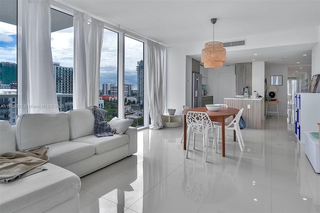 600 NE 27th St Unit 1105, Miami, FL 33137 - living area featuring a city view, expansive windows, and light tile patterned flooring