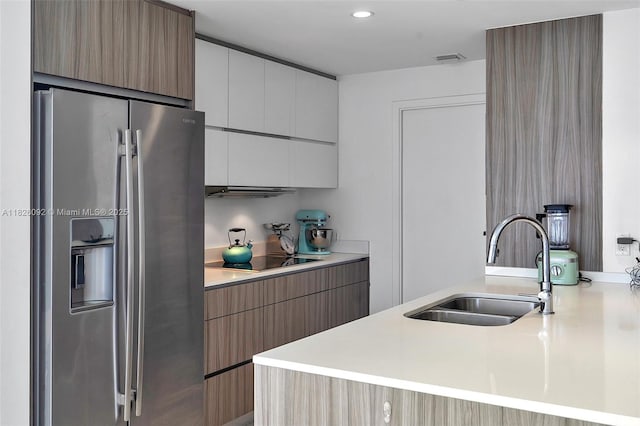 600 NE 27th St Unit 1105, Miami, FL 33137 - kitchen with stainless steel fridge with ice dispenser, modern cabinets, black electric stovetop, light countertops, and recessed lighting