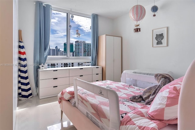 600 NE 27th St Unit 1105, Miami, FL 33137 - bedroom with a view of city and light tile patterned floors