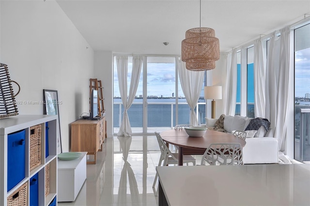 600 NE 27th St Unit 1105, Miami, FL 33137 - dining room with healthy amount of natural light, light tile patterned floors, and a wall of windows