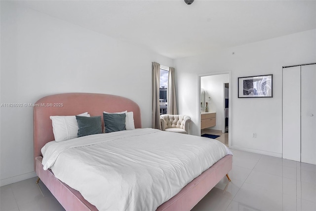 600 NE 27th St Unit 1105, Miami, FL 33137 - tiled bedroom featuring ensuite bath and baseboards