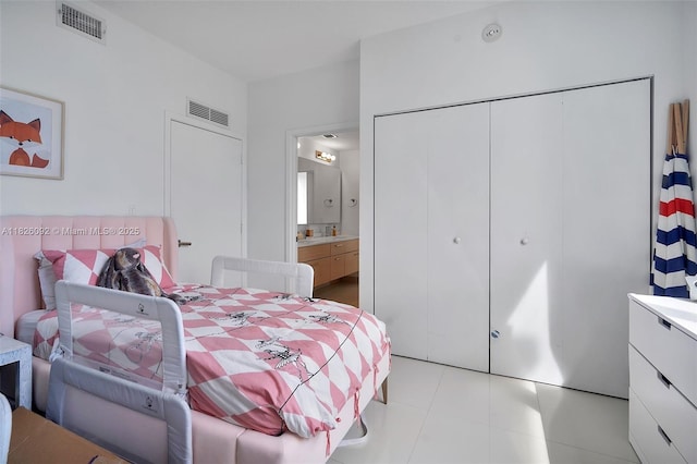 600 NE 27th St Unit 1105, Miami, FL 33137 - bedroom with a closet, ensuite bathroom, and light tile patterned floors