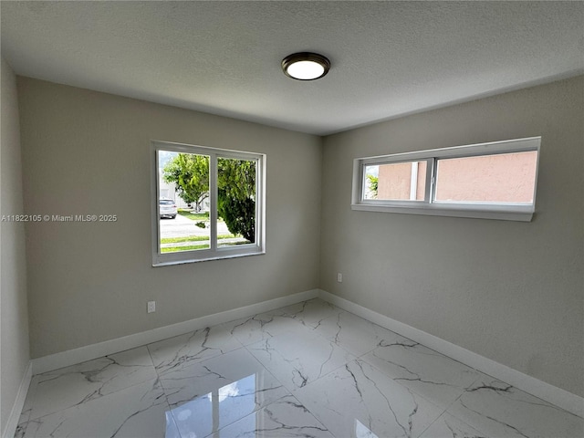10000 Olive St, Miramar, FL 33025 - spare room with marble finish flooring and a textured ceiling
