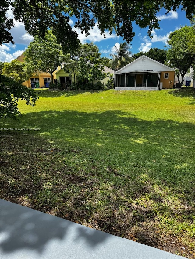 10000 Olive St, Miramar, FL 33025 - view of grassy yard with a sunroom