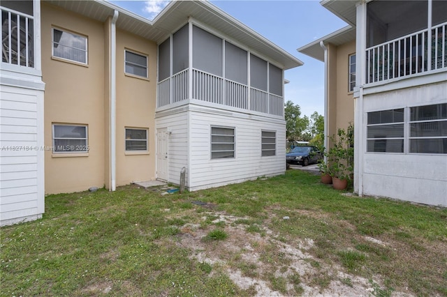3126 Harbor Blvd Unit 1A, Port Charlotte, FL 33952 - back of property featuring stucco siding and a lawn