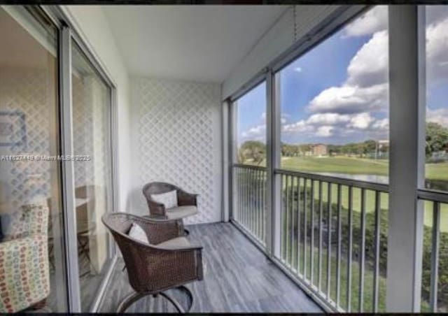 901 SW 128th Ter Unit 205A, Pembroke Pines, FL 33027 - sunroom / solarium featuring wood finished floors, healthy amount of natural light, and wallpapered walls