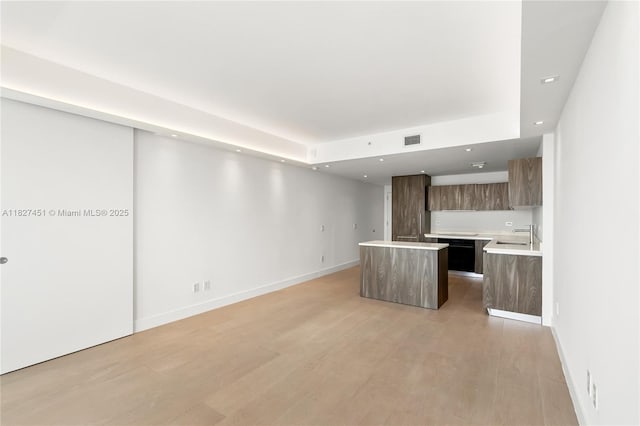 3131 NE 7th Ave Unit 2705, Miami, FL 33137 - kitchen with modern cabinets, a kitchen island, light countertops, light wood-type flooring, and open floor plan