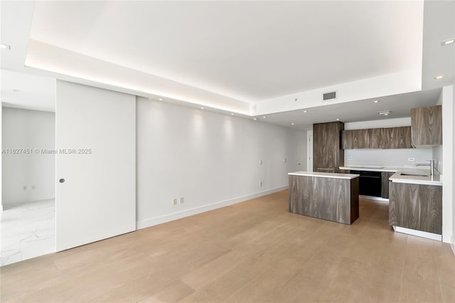 3131 NE 7th Ave Unit 2705, Miami, FL 33137 - kitchen featuring modern cabinets, a center island, light countertops, recessed lighting, and a tray ceiling