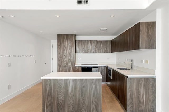 3131 NE 7th Ave Unit 2705, Miami, FL 33137 - kitchen featuring modern cabinets, oven, a center island, light countertops, and light wood-style floors