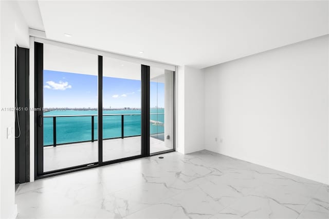 3131 NE 7th Ave Unit 2705, Miami, FL 33137 - empty room with floor to ceiling windows, a water view, and light marble finish floors