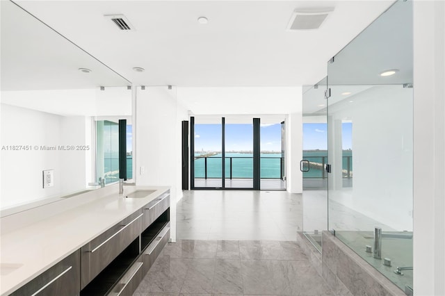 3131 NE 7th Ave Unit 2705, Miami, FL 33137 - full bathroom featuring double vanity, a water view, a bath, a shower, and recessed lighting