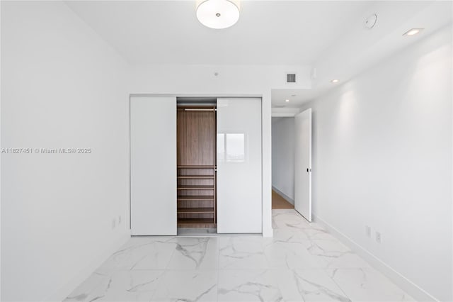 3131 NE 7th Ave Unit 2705, Miami, FL 33137 - unfurnished bedroom featuring a closet, light marble finish floors, and recessed lighting