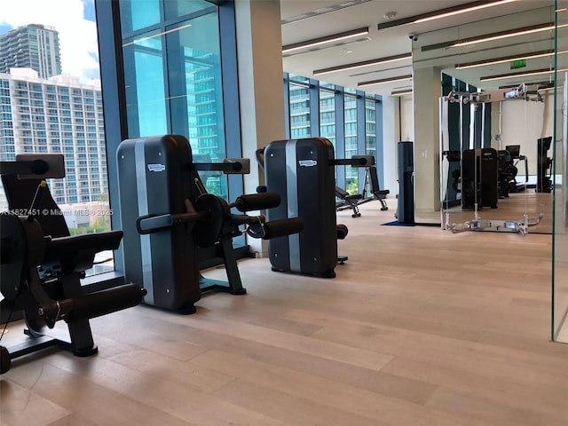 3131 NE 7th Ave Unit 2705, Miami, FL 33137 - gym with wood finished floors and floor to ceiling windows