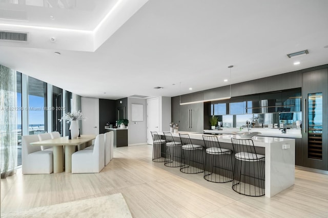 851 NE 1st Ave Unit 5202, Miami, FL 33132 - kitchen with modern cabinets, a spacious island, a kitchen bar, and light countertops