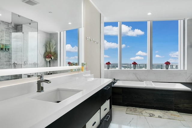 851 NE 1st Ave Unit 5202, Miami, FL 33132 - bathroom featuring a garden tub, vanity, marble finish floors, and recessed lighting