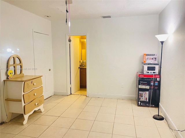 1905 NW 155th St, Miami Gardens, FL 33054 - bedroom featuring light tile patterned floors and connected bathroom
