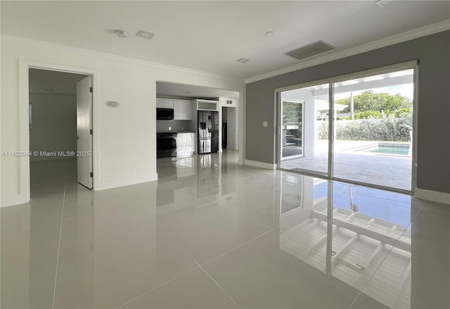 1321 Garfield St, Hollywood, FL 33019 - unfurnished room featuring crown molding, light tile patterned floors, and a smoke detector