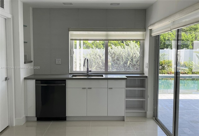 1321 Garfield St, Hollywood, FL 33019 - kitchen featuring dishwashing machine, white cabinetry, light tile patterned floors, and dark countertops