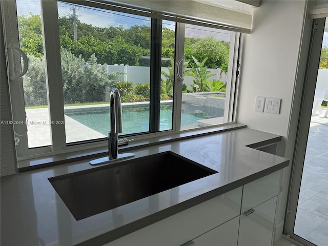 1321 Garfield St, Hollywood, FL 33019 - kitchen featuring a sink and white cabinets