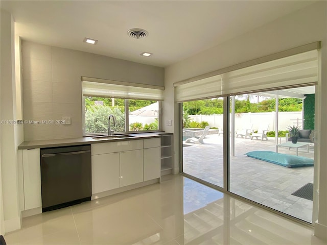 1321 Garfield St, Hollywood, FL 33019 - kitchen with dishwasher, white cabinetry, light tile patterned flooring, and modern cabinets
