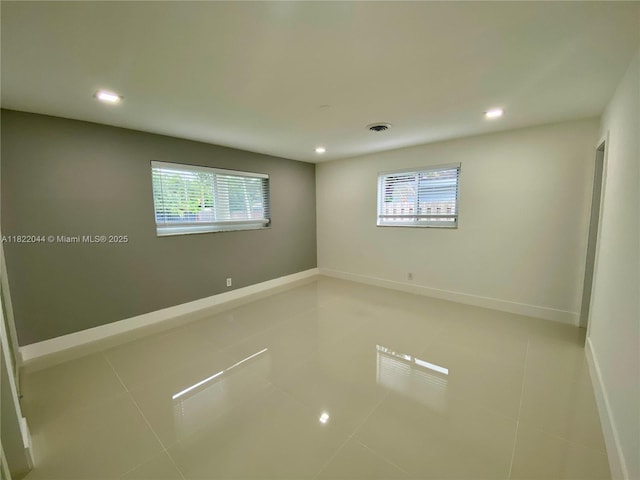 1321 Garfield St, Hollywood, FL 33019 - empty room with healthy amount of natural light, recessed lighting, and tile patterned floors