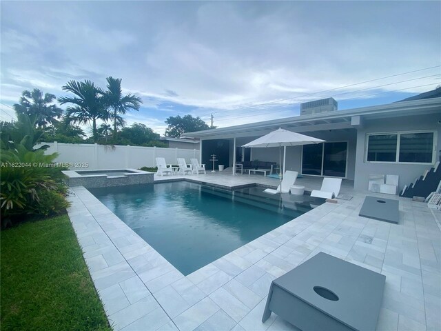 1321 Garfield St, Hollywood, FL 33019 - view of pool featuring a fenced backyard, a patio area, and a pool with connected hot tub