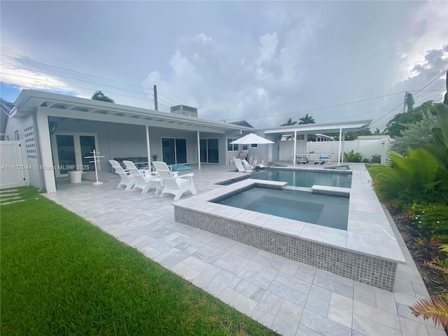 1321 Garfield St, Hollywood, FL 33019 - view of pool featuring a patio area, a fenced backyard, and a pool with connected hot tub