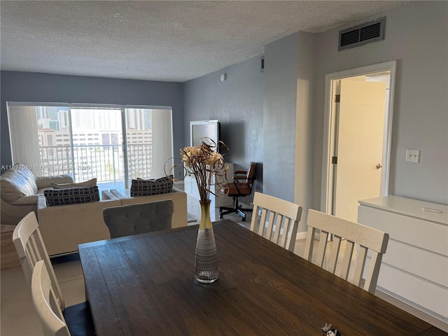 300 Bayview Dr Unit 1009, Sunny Isles Beach, FL 33160 - dining room featuring a textured ceiling