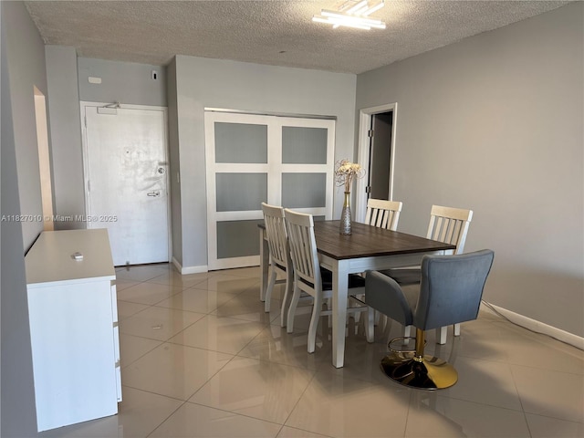 300 Bayview Dr Unit 1009, Sunny Isles Beach, FL 33160 - dining room featuring a textured ceiling and light tile patterned flooring