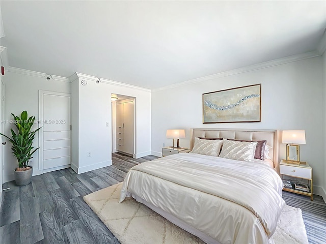bedroom with crown molding and wood finished floors