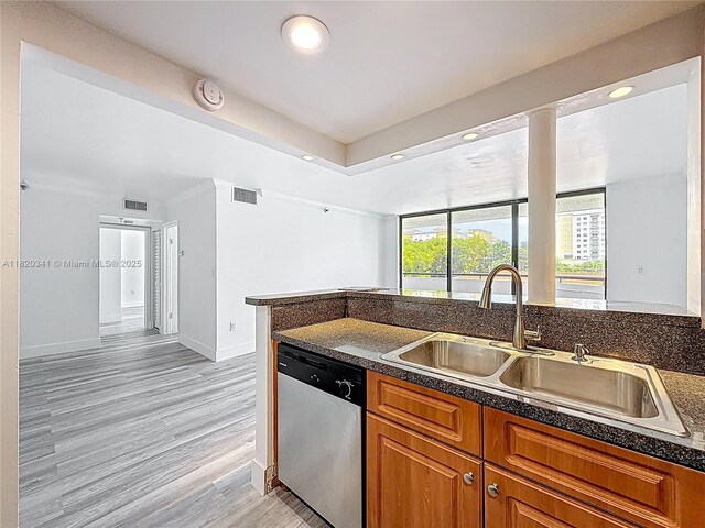 kitchen featuring dishwasher, dark countertops, recessed lighting, and brown cabinetry