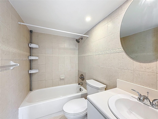 full bath with tile walls, washtub / shower combination, and vanity