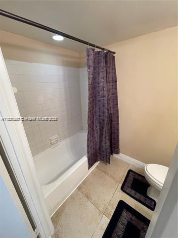 5780 Rock Island Rd Unit 354, Tamarac, FL 33319 - bathroom featuring shower / tub combo with curtain and tile patterned floors