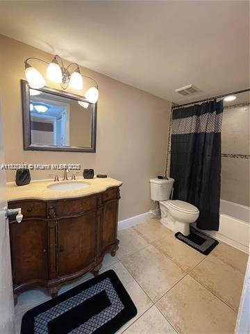 5780 Rock Island Rd Unit 354, Tamarac, FL 33319 - bathroom with vanity, tile patterned floors, and shower / bath combination with curtain