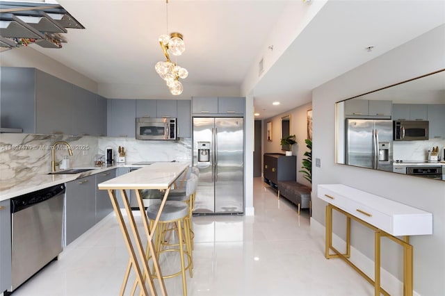 41 SE 5th St Unit 2306, Miami, FL 33131 - kitchen with stainless steel appliances, gray cabinets, tasteful backsplash, and recessed lighting