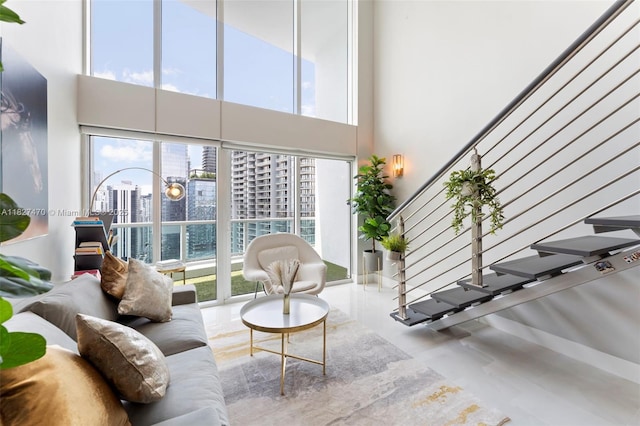 41 SE 5th St Unit 2306, Miami, FL 33131 - living room featuring a city view, plenty of natural light, stairs, and a high ceiling