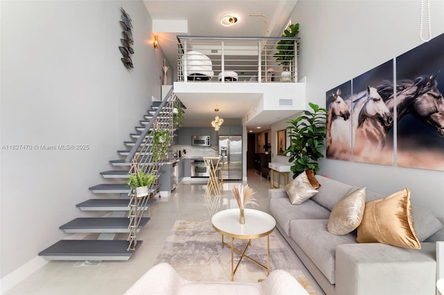 41 SE 5th St Unit 2306, Miami, FL 33131 - living area featuring stairway, a high ceiling, and light tile patterned floors