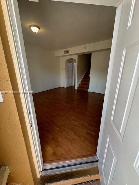 11479 NW 60th Ter Unit 372, Doral, FL 33178 - empty room featuring wood finished floors, stairs, and arched walkways