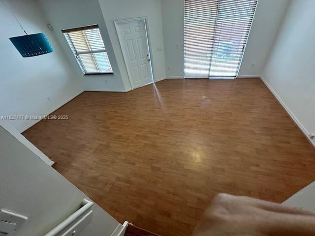 11479 NW 60th Ter Unit 372, Doral, FL 33178 - unfurnished living room with wood finished floors and baseboards